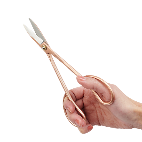 Close-up of a hand holding Rose Gold Satsuki Floral Scissors
