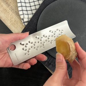 Grating ginger with Tomita stainless steel grater